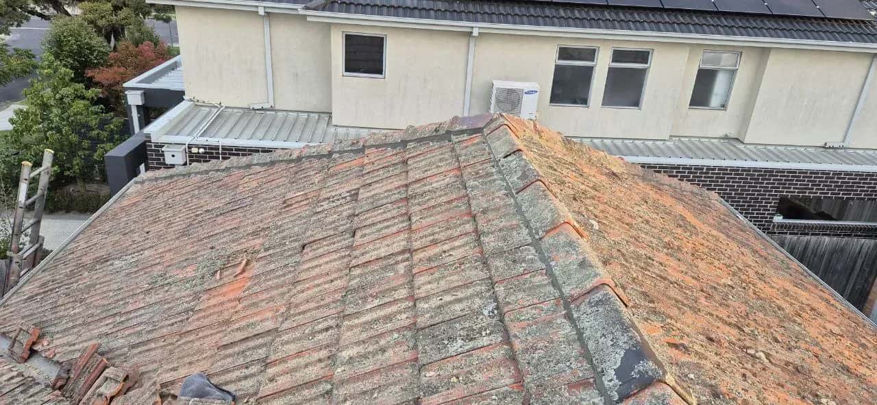 Frankston concrete tile roof before restoration - faded colour with lichen growth and cracked pointing