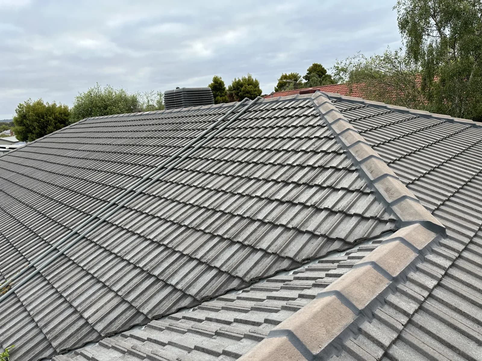 Professional roofer inspecting a tile roof for hidden damage in Frankston — identifying early warning signs before they become costly repairs