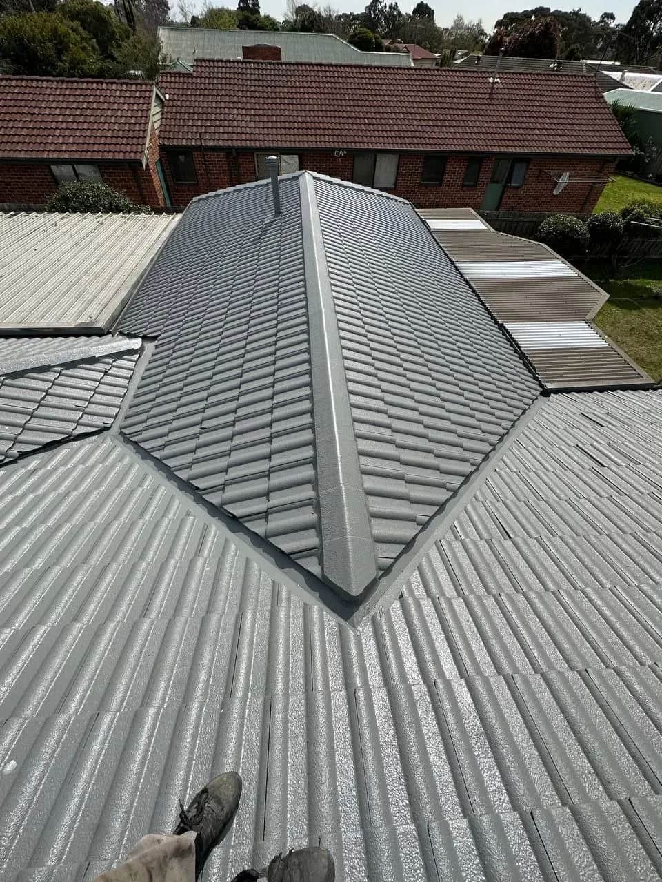 Professional roof restoration in progress on a Mornington Peninsula home showing pressure cleaning and repointing