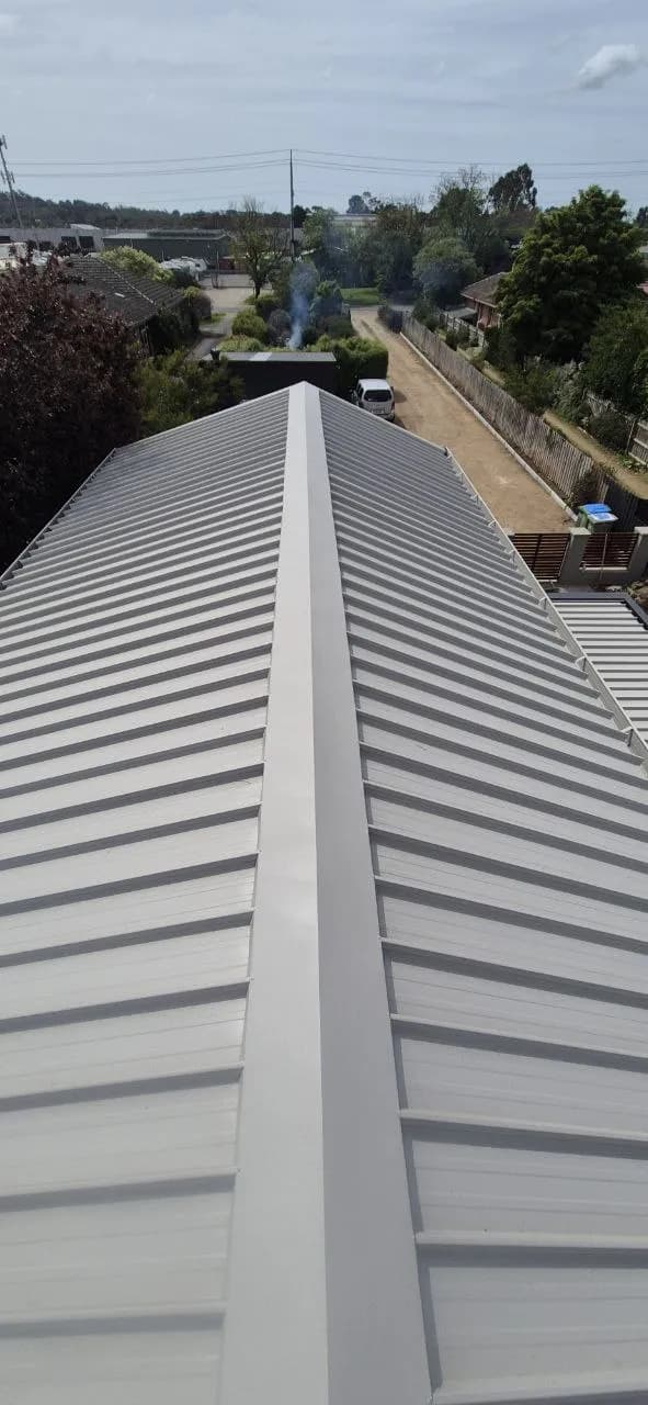 Professional roof flashing repair on a coastal Mornington Peninsula home showing new valley flashing installation