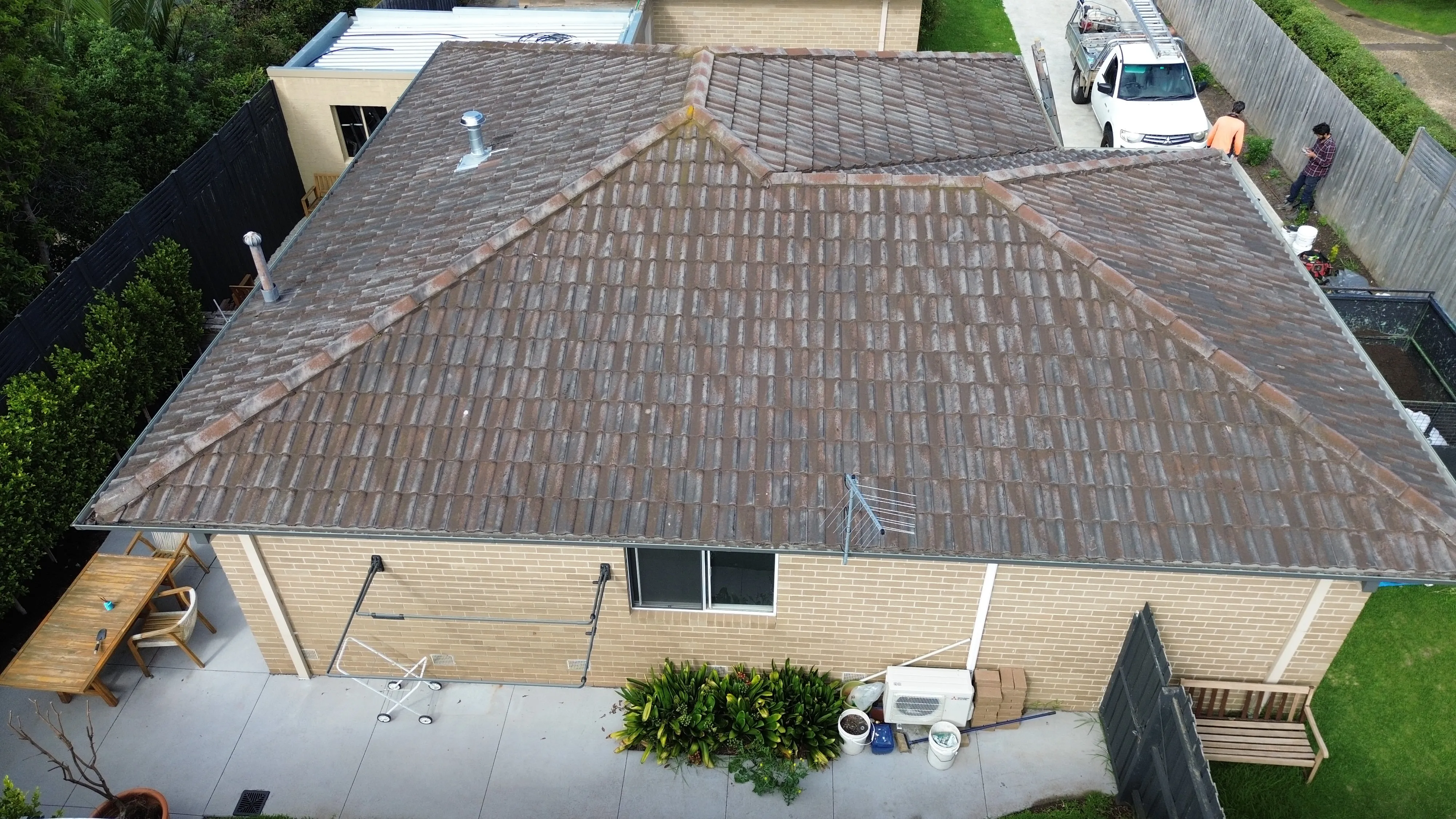 Colorbond metal roof before painting - rust spots and UV fading visible